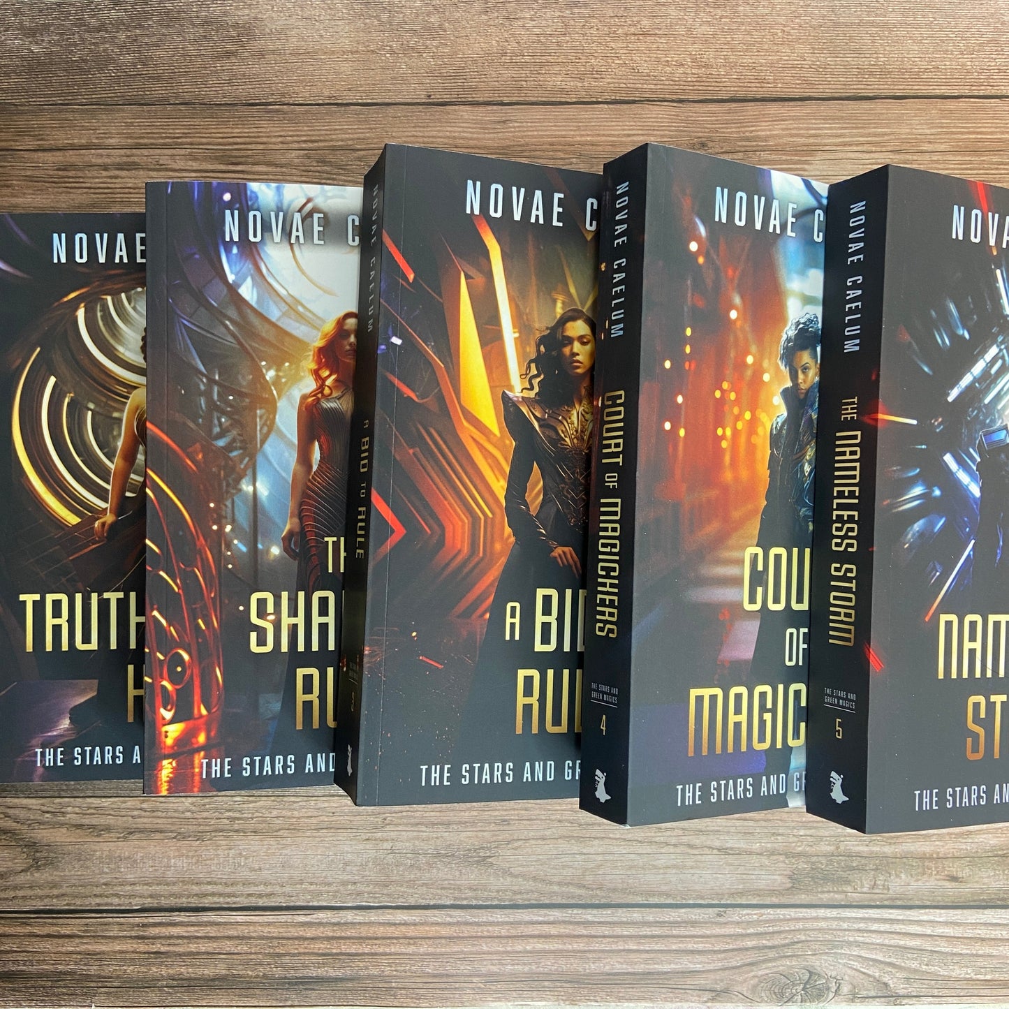 Set of 5 paperbacks (Books 1-5) from "The Stars and Green Magics" series by Novae Caelum arranged in a staggered row. This collection is part of the SCRATCH AND DENT - SIGNED Paperback Deluxe Swag Bundle.