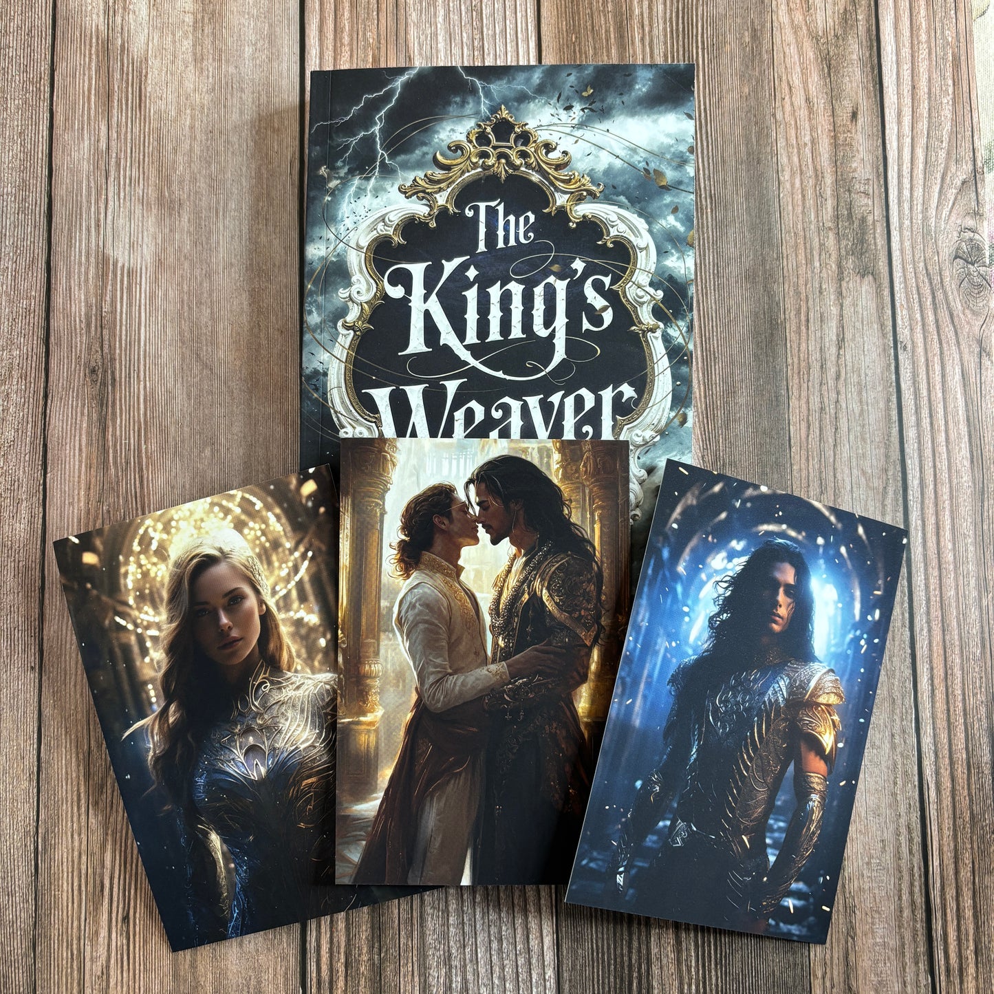 A print copy of "The King's Weaver" along with three art cards depicting the main characters.