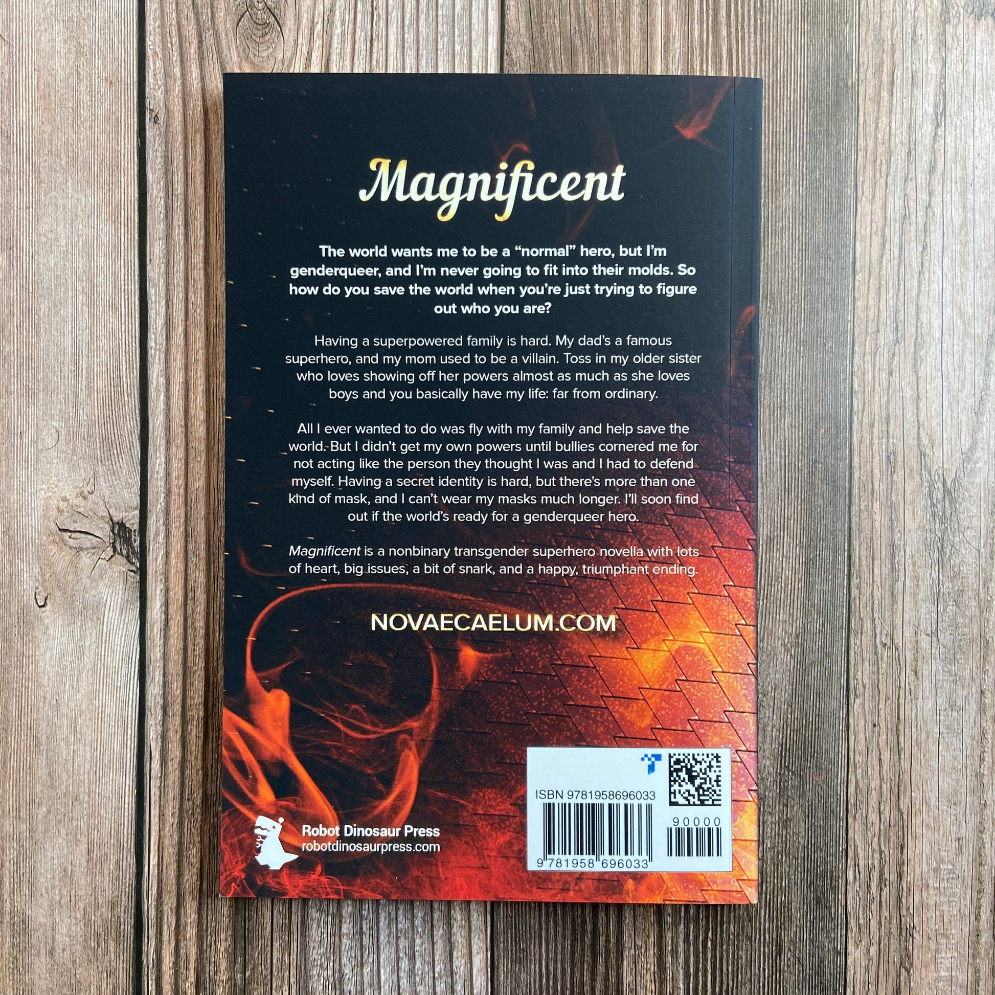Back of paperback titled "Magnificient: A Nonbinary Superhero Novella" by Novae Caelum, with the tagline of: "The world wants me to be a 'normal' hero, but I'm genderqueer, and I'm never going to fit into their molds. So how do you save the world when you're just trying to figure out who you are?"