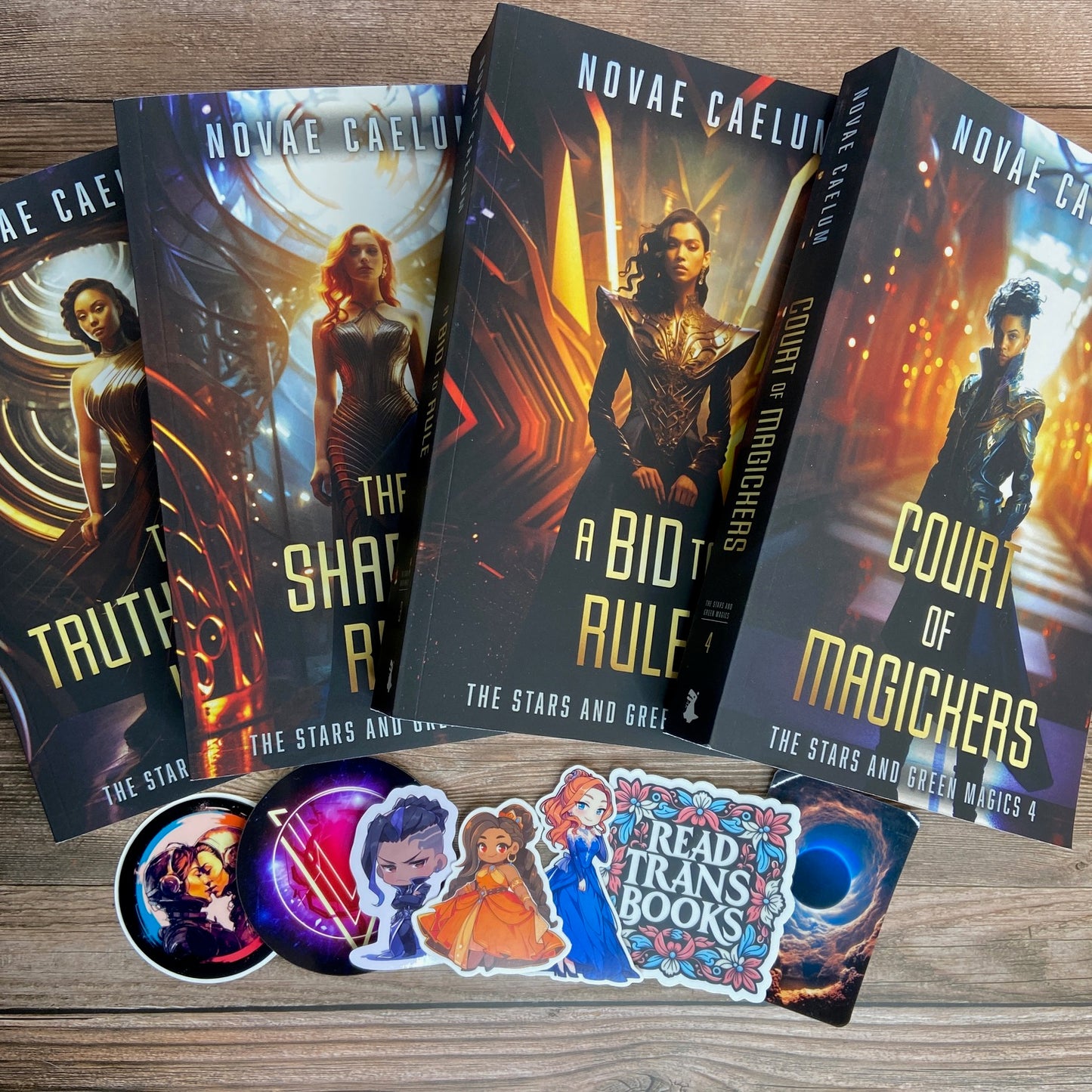 Bundle of 4 paperbacks (Books 1-4) from "The Stars and Green Magics" series by Novae Caelum; there are also 7 series-related swag pieces arranged below the books.