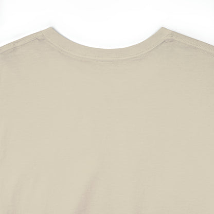 Close-up of the back collar of a sand-colored t-shirt; the shirt image (not pictured) displays a psychedelic cat in the Transgender Pride flag colors.