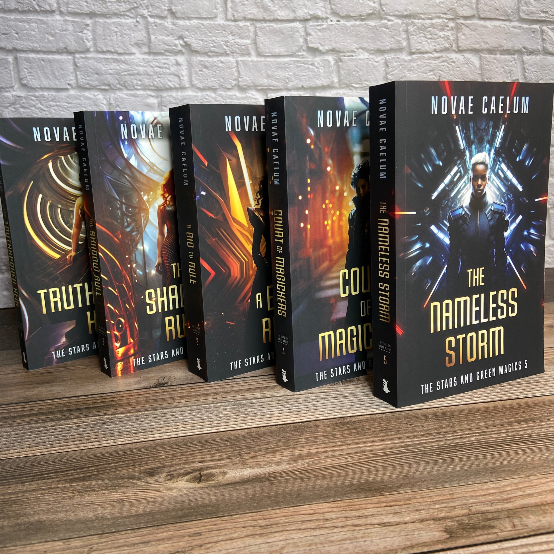 Set of 5 paperbacks (Books 1-5) from "The Stars and Green Magics" series by Novae Caelum standing in a staggered row. This collection is part of the Paperback Deluxe Swag Bundle.