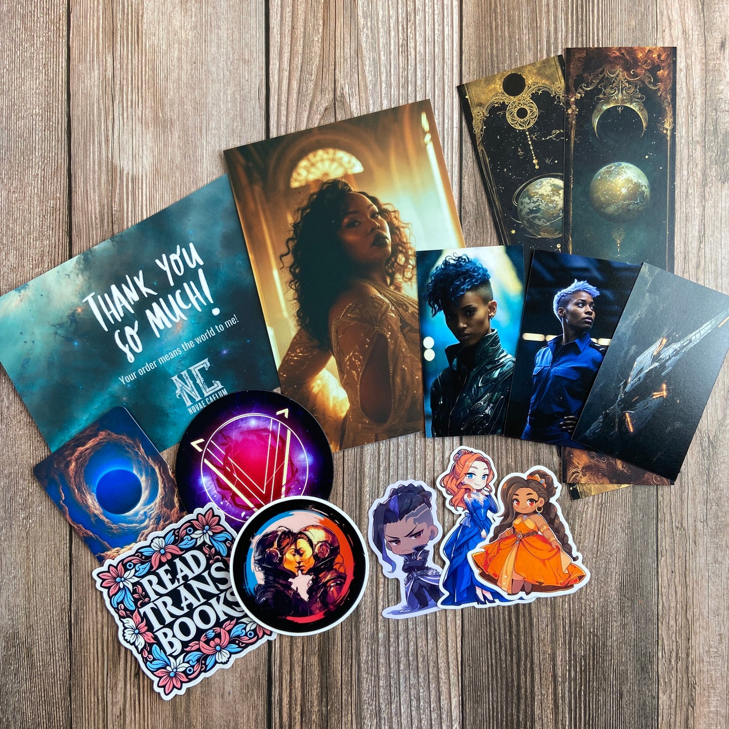 A collection of swag (cards, vinyl stickers, bookmarks) from Novae Caelum's "The Stars and Green Magics - Books 1-5". This collection is part of the Paperback Deluxe Swag Bundle.