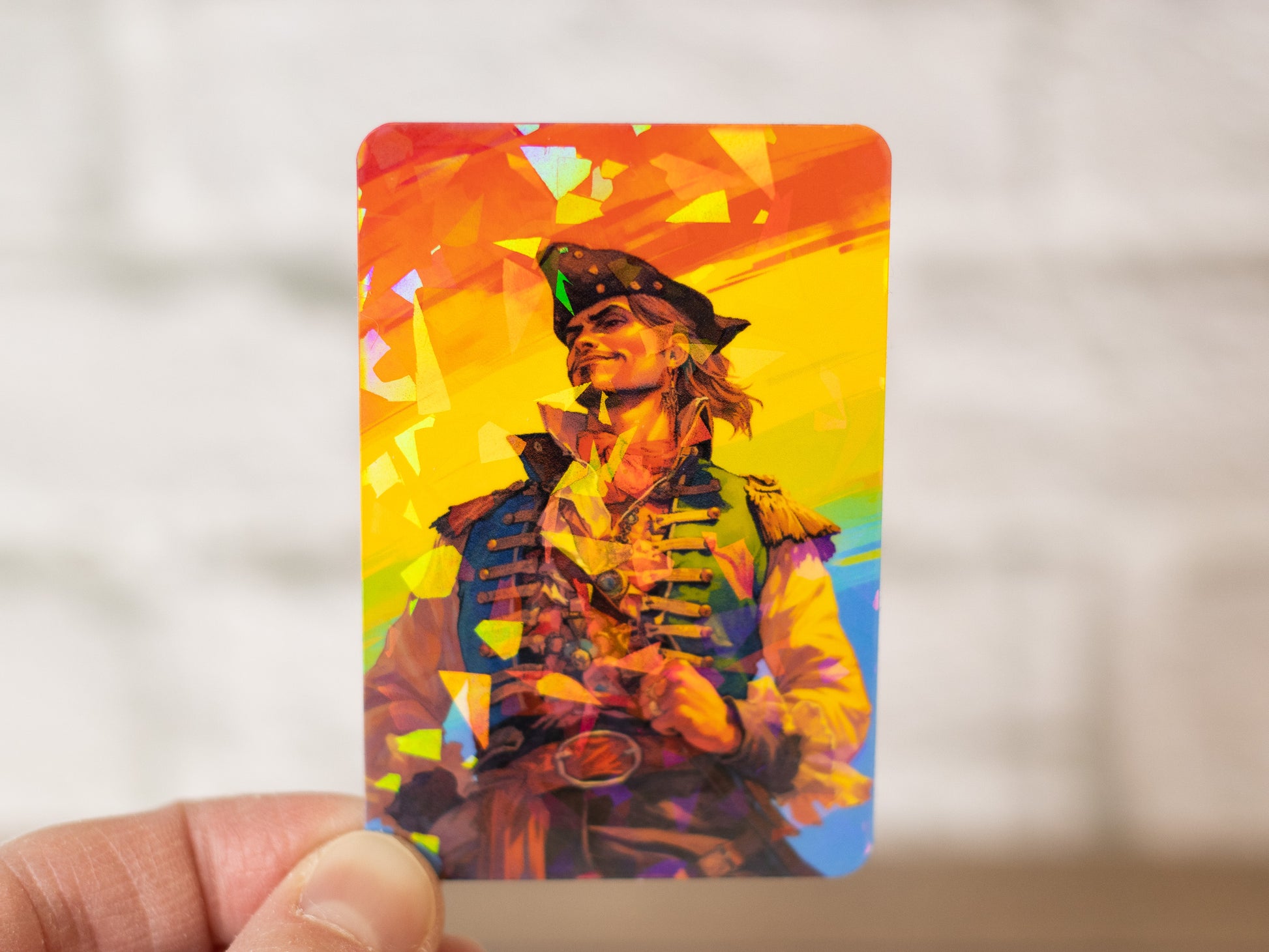 A person holding up a pride flag with a Novae Caelum LGBT Pride Rainbow Gay Pirate Holographic Vinyl Sticker.
