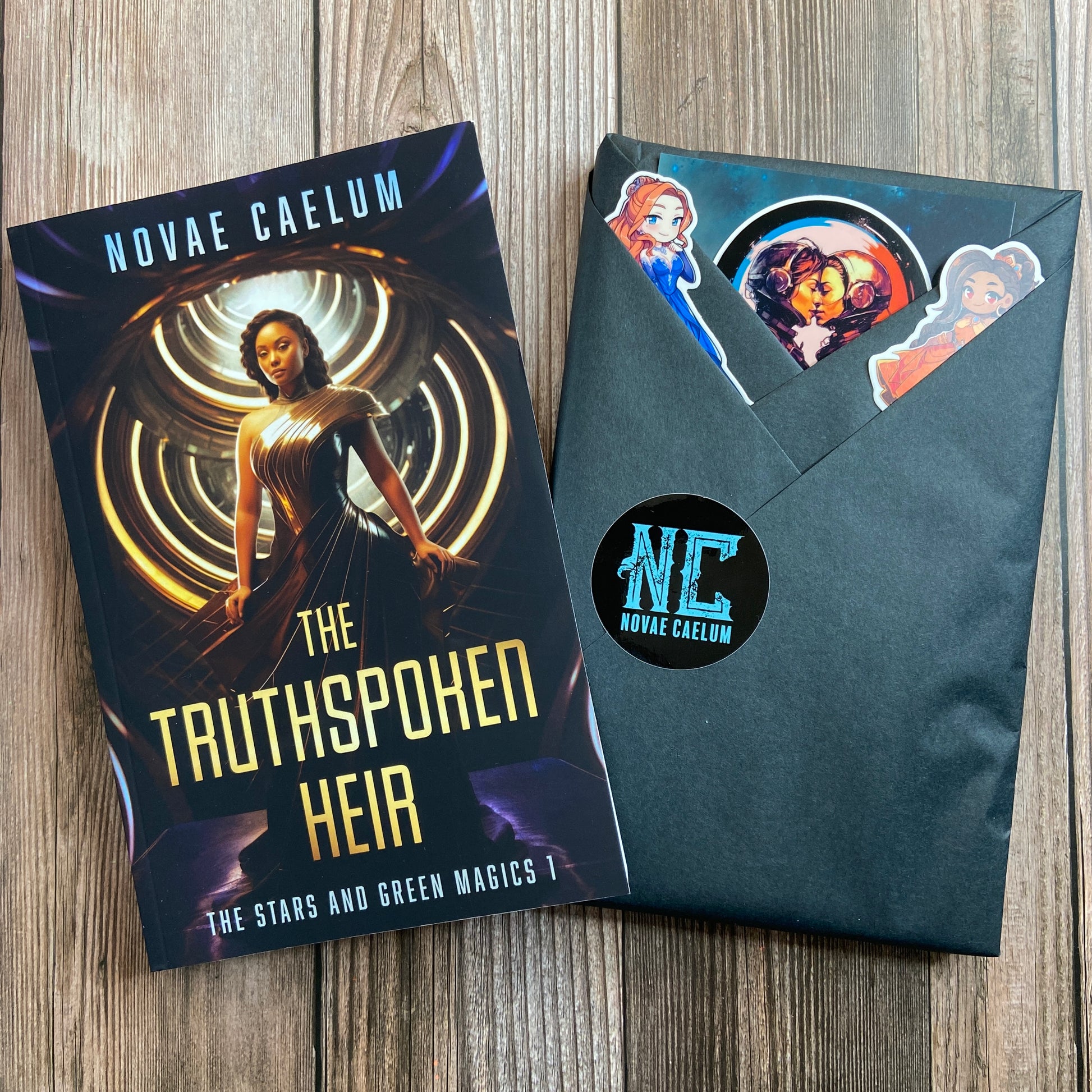 A paperback book titled "SIGNED The Truthspoken Heir: The Stars and Green Magics Book 1" by Novae Caelum, exploring themes of forbidden love and shapeshifting powers, alongside an envelope with stickers featuring characters from the book.