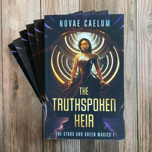 A stack of Novae Caelum books titled "SCRATCH AND DENT - SIGNED The Truthspoken Heir: The Stars and Green Magics Book 1" featuring a cover image of a woman with shapeshifting powers, standing with glowing rings in the background.