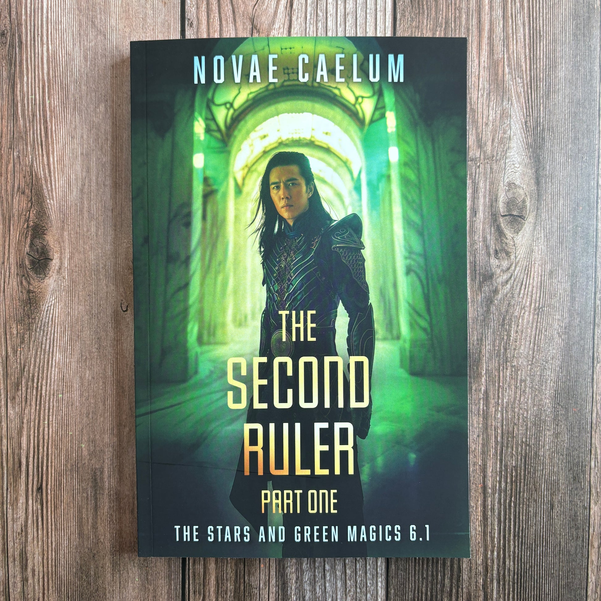 Paperback cover of the book "The Second Ruler: Part One: The Stars and Green Magics - Book 6.1" by Novae Caelum, featuring an image of a man of East Asian descent wearing intricate scifi clothing in a glowing green marble corridor.