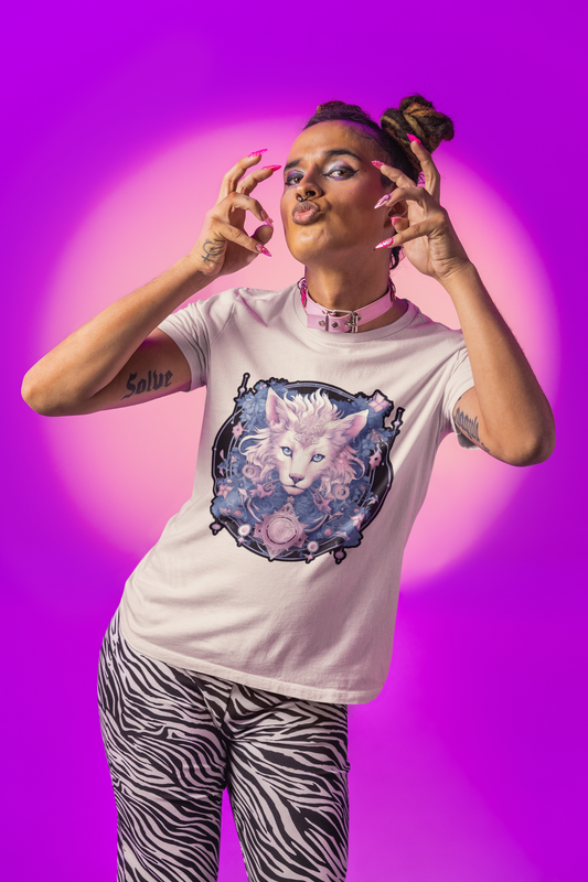 Mockup of an individual with several tattoos wearing a sand-colored shirt while posing in front of a color gradient background; the shirt image displays a psychedelic cat in the Transgender Pride flag colors.